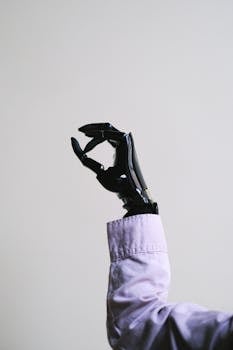 A modern prosthetic hand making an OK gesture, symbolizing advanced technology.