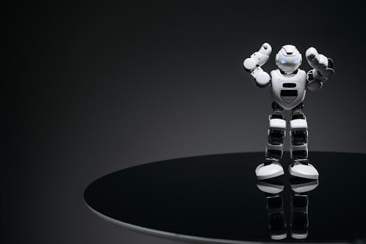 A small humanoid robot with glowing eyes on a reflective table in a dark setting.