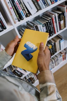 Close-up of a person holding a 'Gen Z' book against a library background.