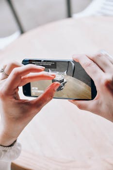 Hands holding a smartphone with augmented reality application indoors.